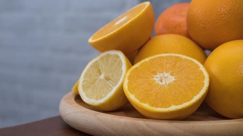 Close-up of oranges on plate at table