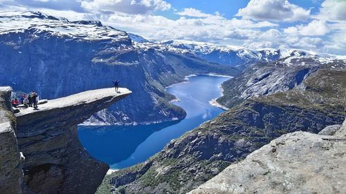 High angle view of people at trolltunga against mountains