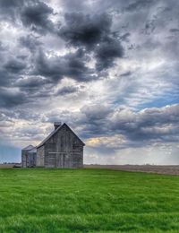 Built structure on field against sky