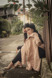 Portrait of smiling young woman standing on street