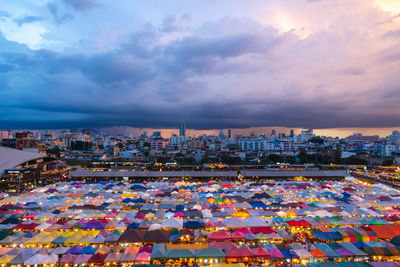 High angle view of illuminated city buildings at sunset