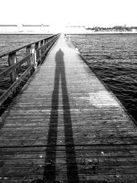 Pier over sea against clear sky