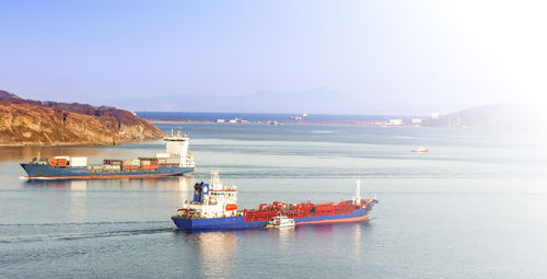 Selective focus. the large container ship and reefer ship at blue sea in soft sunlight