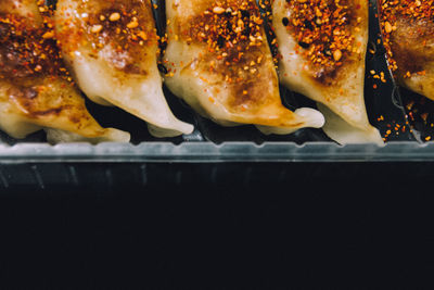 Close-up of food in container over black background