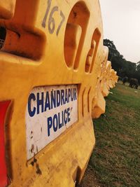 Close-up of information sign on field