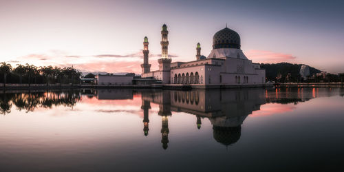 Reflection of church in lake at sunset