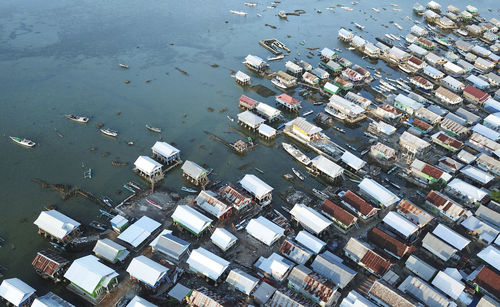 Aerial view of stilt houses in sea