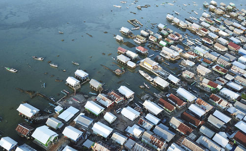 High angle view of buildings by sea in city