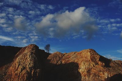 Low angle view of rock formations against sky