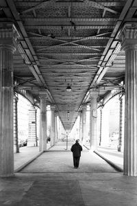 Rear view of man walking in building