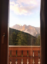 View of mountains against sky seen through window