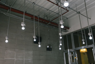 Low angle view of illuminated lights hanging on ceiling