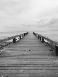 Pier over sea against sky