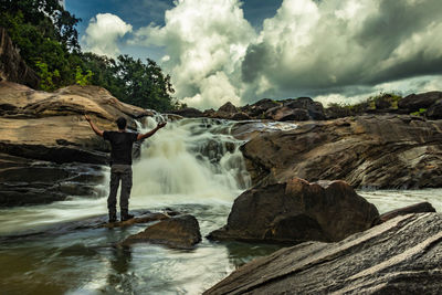 Scenic view of waterfall against rocks