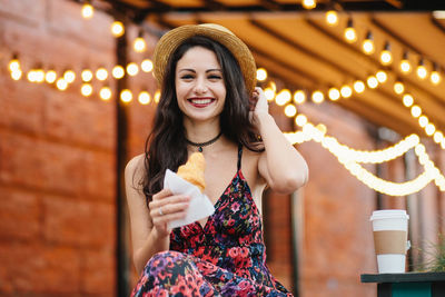 Portrait of a beautiful young woman drinking drink