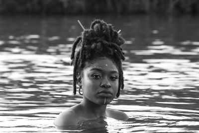 Portrait of young woman swimming in lake