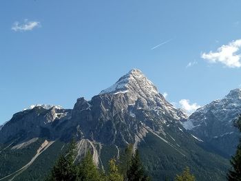 Panoramic view of snowcapped mountains against clear blue sky