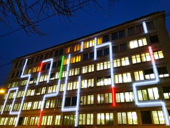 Low angle view of building against clear sky at night