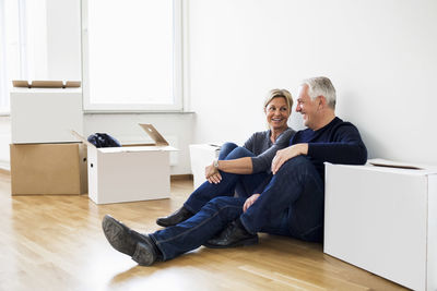 Mature couple relaxing after moving into their new house