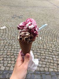 Cropped hand holding ice cream cone