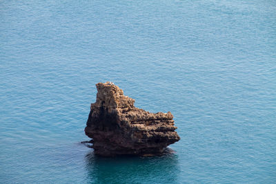 High angle view of rock formation in sea