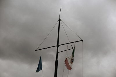 Low angle view of flags hanging against sky