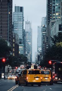 Traffic on city street by buildings