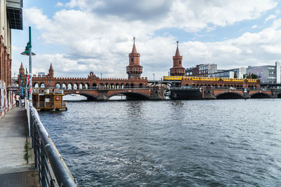 Boats in river with buildings in background