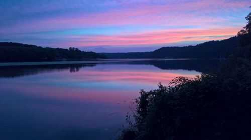 Scenic view of lake against romantic sky at sunset