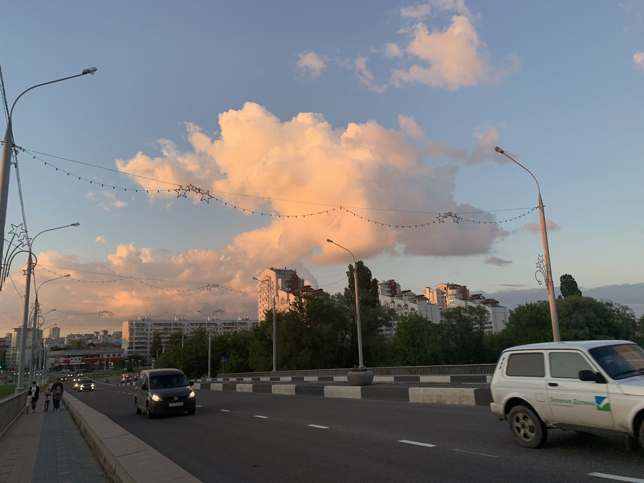 CARS ON STREET AGAINST SKY