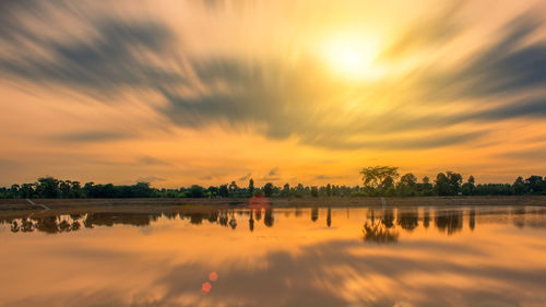 Scenic view of lake against orange sky