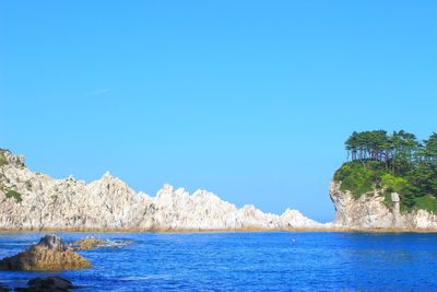 Scenic view of sea against clear blue sky