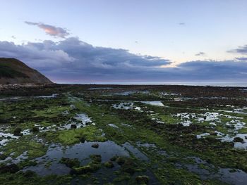 Scenic view of sea against cloudy sky
