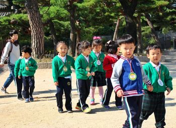 Portrait of children standing in park