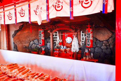 People at market stall building