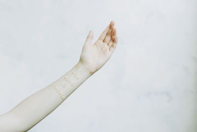 Close-up of hand against white background