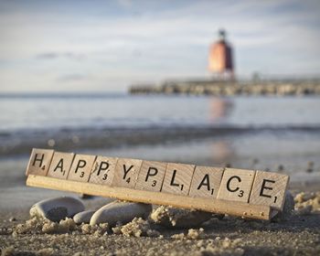 Close-up of text on beach