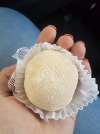 Close-up of hand holding ice cream