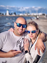 Young man wearing sunglasses at sea shore