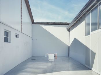 Clothes drying stand on flooring amidst buildings