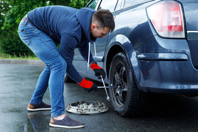 Low section of man holding car