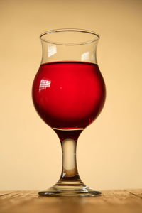 Close-up of red wine in glass on table