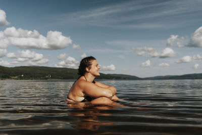 Woman sitting in lake