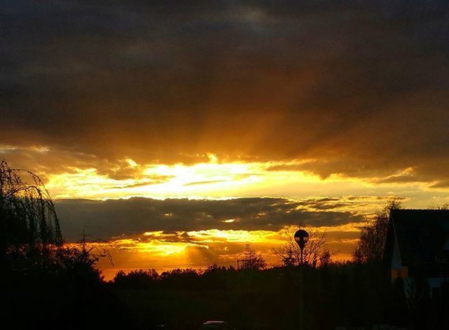 sunset, sky, silhouette, orange color, cloud - sky, scenics, beauty in nature, tranquil scene, building exterior, dramatic sky, tranquility, cloud, nature, idyllic, cloudy, built structure, tree, architecture, moody sky, landscape