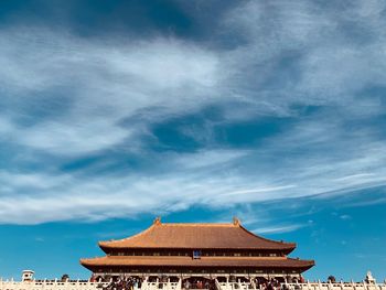 Low angle view of building against cloudy sky