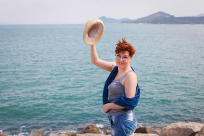 Young woman standing at beach
