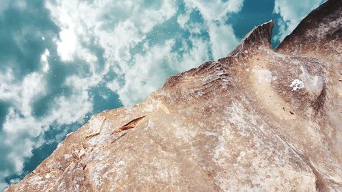 Low angle view of rock against sky