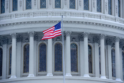 Flag against sky in city