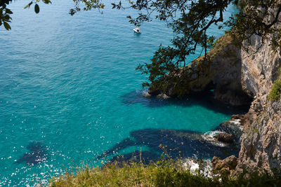 High angle view of rocks by sea
