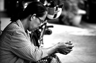 Side view of woman using mobile phone